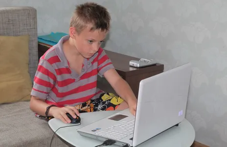 Me at twelve, hunched over a laptop, deep in focus